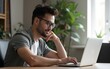 © Elizabeth - Man using laptop and mobile phone while working from home. High quality