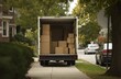 © Andrii Zastrozhnov - Moving truck on suburban street with boxes in open back during autumn day