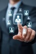 © Halina - Businessman touching virtual screen with employee icons representing digital recruitment and human resource management