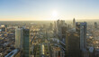 © AmazingAerialAgency - Aerial view of skyscrapers piercing the skyline, bathed in the golden light of the setting sun, a mesmerizing urban panorama., Frankfurt am Main, Hessen, Germany.