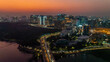© AmazingAerialAgency - Aerial view of a city skyline with its buildings lit up against the dusk sky, showcasing its vibrant urban landscape, Hyderabad, Telangana, India.