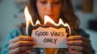 © Pixsite - Woman holding burning paper with good vibes only message