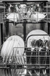 © wedmoments.stock - Dishwasher interior filled with clean plates, glasses, and cutlery arranged neatly in baskets, showcasing efficient kitchen appliance design and organization for modern households