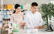 © JackF - Guy pharmacist at checkout area of pharmacy sells pack of pills to girl visitor, serves client and informs about possible side effects in case of overdose, consulting about doctors prescription