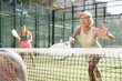 © JackF - Sportive elderly woman engaged in Padel Tennis in open-air court of tennis club