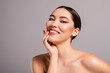 © Beauty Hero - Portrait of a young confident woman with perfect skin and tasteful makeup on a neutral backdrop