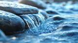 Clear water cascades over smooth stones in a natural stream