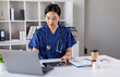 © David - Nurse, asian female doctor using laptop online, writing notes in medical journal sitting at desk, professional medic physician working on computer at workplace, med student learning, planning