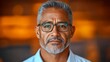 © songsi - Mature man with glasses and silver hair in a thoughtful expression, warm background bokeh effect, portrait focus