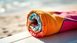 © Xingguo - rashguard. A colorful rolled-up rashguard resting on a surfboard at the beach. event key visuals, club posters, designed for fitness apps and gym onboarding, drives event promotion.