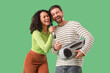 © Pixel-Shot - Young couple with microphone and boombox singing on green background
