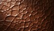 © Wil BG - The brown leather texture features a close-up view of a shiny surface with a natural, wrinkled pattern.