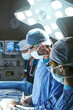 © peopleimages.com - Surgeon, help and people in operating room, healthcare and clinical support with lights. Technique, professional and employees in hospital, medical emergency service or teamwork with procedure or icu