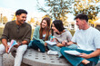 © DMegias - Diverse students laughing enjoying campus life outdoor