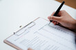 © Lahmz - Person filling mental health checklist on clipboard with pen, psychological assessment, self evaluation, healthcare screening and wellbeing awareness concept.