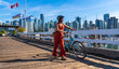© unai - Tourist walking with bicycle on pier in vancouver, british columbia