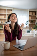 © Migma_Agency - Woman celebrating online shopping success with credit card