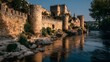 © horizon - Ancient stone fortress walls stretch along a riverbank with golden hour sunlight hitting the stonework highlighting historical architecture.