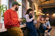 © master1305 - Team members talking during informal break in modern office. Concept of workplace culture, internal communication, startup environment, team bonding, and modern business lifestyle.