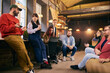 © master1305 - Colleagues discussing ideas in open space office interior. Concept of brainstorming sessions, teamwork, creative workflow, startup collaboration, and business communication.