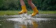 © Emin - Bright yellow rain boots placed in a wet environment, footwear safety during rainy weather