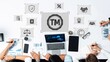 © InfiniteFlow - A group of professionals collaborates on trademark and brand protection strategies, using modern technology and visual aids to enhance legal concepts and teamwork efforts. Raster