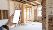 © NOYON HOSSAIN - Person Holding Cell Phone Mockup at Construction Site with Exposed Brick and Framing