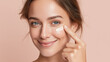 © Marut - Soft glass skin brightness on young woman with radiant complexion, pastel rose beige background, natural beauty, healthy glow, gentle skincare, joyful expression