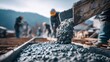 © InfiniteStudio - Workers mix concrete on a construction site in the mountains in daylight with a clear sky and scenic background