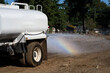 © knelson20 - New residential housing development construction site, non-potable water truck spraying water to keep dust down during earthworks project, rainbow on sunny fall day