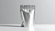 © Layar - Shiny, metallic pouch stands upright on a white surface with subtle shadows