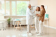 © Pixel-Shot - Young lesbian couple visiting fertility doctor about IVF in clinic