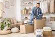© Pixel-Shot - Young man with folded jeans and wardrobe boxes in dressing room