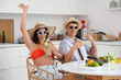 © Pixel-Shot - Happy young tourists couple with glasses of mojito and ingredients sitting in kitchen