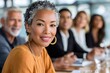 © Lubos Chlubny - Diverse business team meeting with mature confident businesswoman