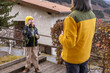 © Guzel - Child blows bubbles while standing on a wooden deck near a house in the mountains during daytime