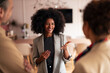 © Jelena - Professional Woman In Grey Blazer Engages Friends During Casual Office Conversation