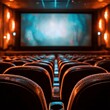 © Anastasiia - Rows of empty theater seats with a large movie screen showing a blue glow before the film starts