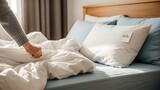 Person Making Bed with Fresh Linens.