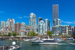 © unai - Motorboat cruising past vancouver skyline on sunny summer day