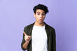 © luismolinero - Young Venezuelan man isolated on purple background intending to realizes the solution while lifting a finger up