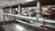 © Justlight - Medium shot focusing on pipe joints and fixture connections in a commercial kitchen plumbing system with stainless steel surfaces.