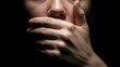 © Andri - A hand covers a person's mouth in stark, low-key lighting, emphasizing intense silence, censorship, suppression, and the raw feeling of real fear in the darkness.