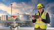 © Grispb - Oil refinery inspection, process control. Industrial engineer reviews data on a tablet near pipelines and storage tanks, monitoring operations, safety, and energy infrastructure.