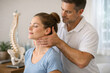 © tonstock - Therapy rehabilitation posture neck ergonomics | practitioner performing gentle manual neck adjustment on relaxed adult patient in clinic to improve mobility and relieve pain