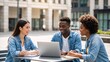 © Vasiliy - Multi-ethnic group of students studying together outdoors with a laptop. Happy young friends collaborating on a project at a university campus