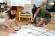 © Stella 16 - couple assembling wooden furniture together, Young asian couple assembly a new furniture at home