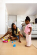 © ADDICTIVE STOCK - Playful black family time in the living room with toys