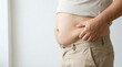 © CK Studio - Overweight person pinching excess belly fat, highlighting weight gain, obesity, and health concerns. Symbolizes body image, diet, and fitness challenges.