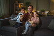 © Miljan Živković - Father and children watching movie on tv at home